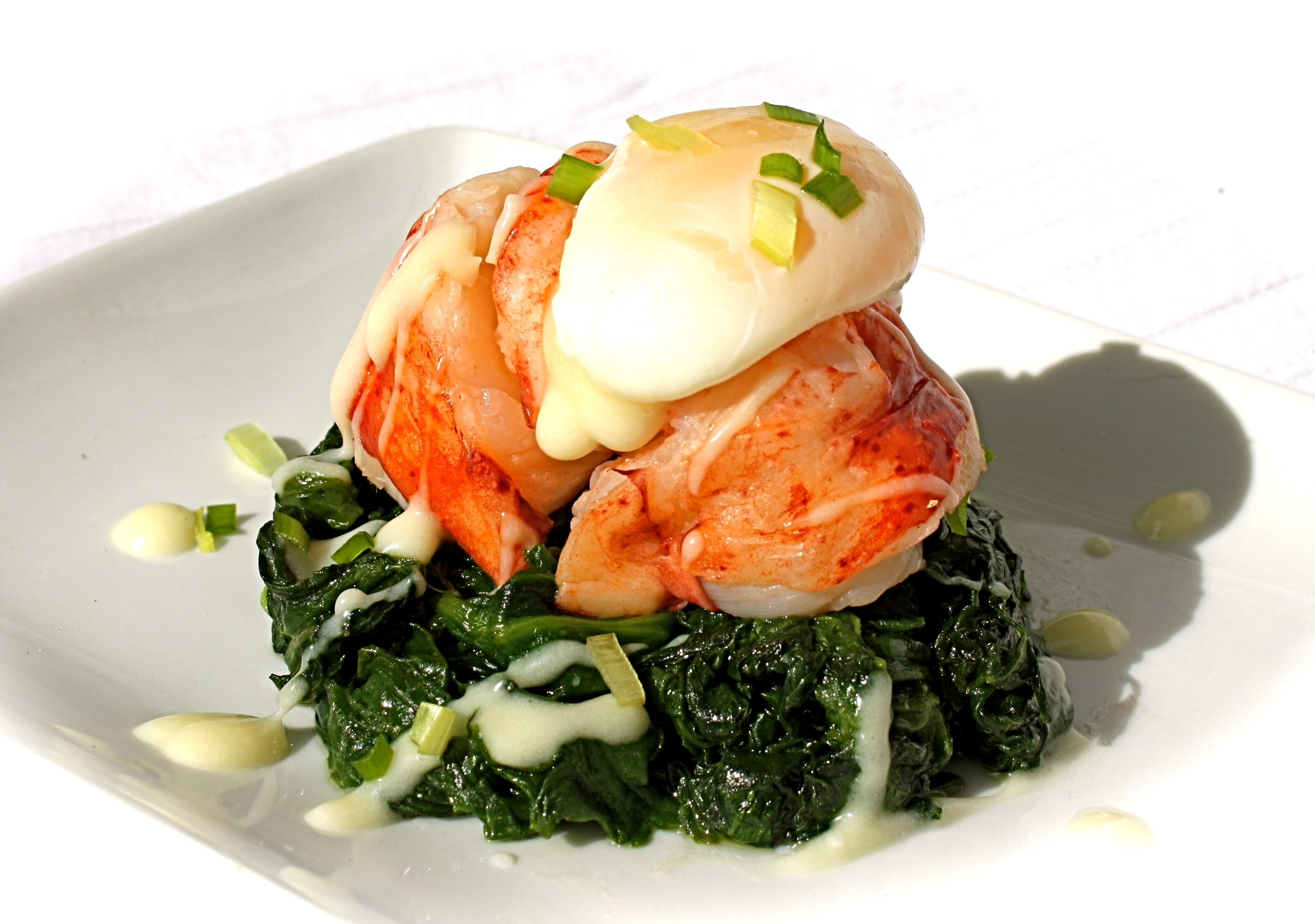 butter-poached-lobster-on-a-bed-of-garlic-spinach-topped-with-a-poached-quail-egg-and-beurre-blanc.jpg